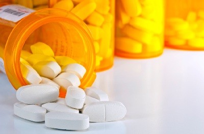 Prescription Medication Spilling From an Open Medicine Bottle
