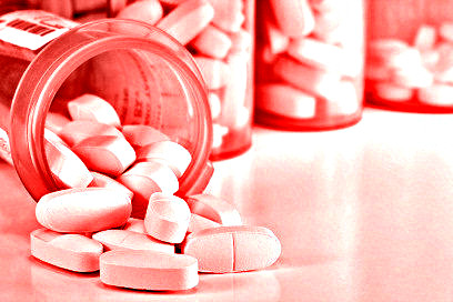 Prescription Medication Spilling From an Open Medicine Bottle