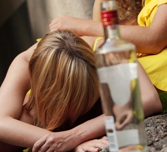 Drunk teens with vodka bottle