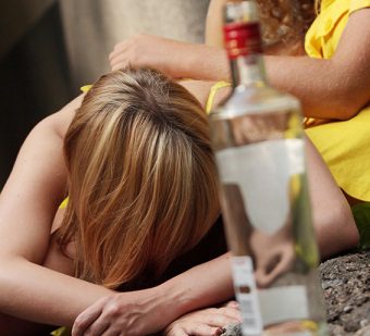 Drunk teens with vodka bottle