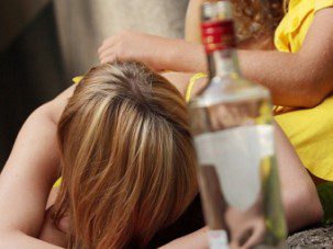 Drunk teens with vodka bottle