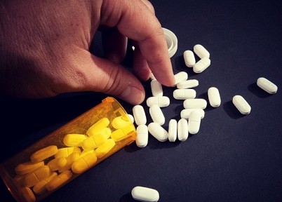 Taking Narcotic Pills, a leading prescription drug that is abused.