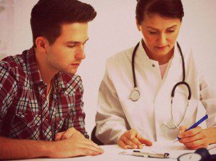 doctor talking to her male patient at office