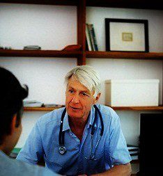 Portrait of a senior doctor advising a client while at the office