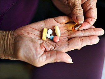 Pills in older woman's hands 5-21-14