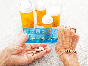 Elderly Hands Sorting Pills