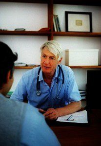 Portrait of a senior doctor advising a client while at the office