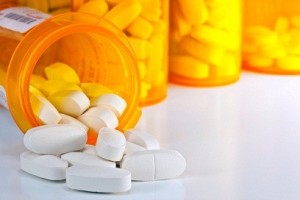Prescription Medication Spilling From an Open Medicine Bottle