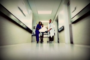 Emergency team rushes a patient down the hospital hallway on a gurney