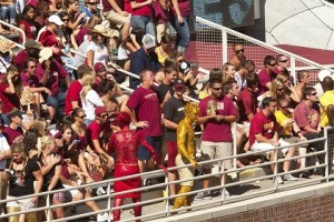 Tallahassee, Florida, USA - October 16, 2010: The Garnet and Gold Guys, two Florida State students who cover their bodies with glitter and paint, continue the tradition of being the ultimate football fans who gets the crowd enthusiastic at home football games at Doak Campbell Stadium.