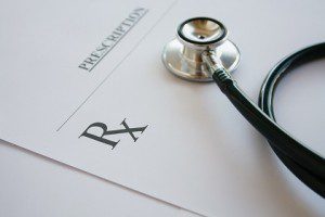 Prescription form lying on table with stethoscope